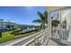 Expansive balcony view overlooking a serene lake and lush landscaping on a bright, sunny day at 7910 34Th W Ave # 203, Bradenton, FL 34209
