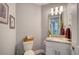 Well-lit powder room with a single sink vanity, decorative mirror, and fresh neutral paint at 7910 34Th W Ave # 203, Bradenton, FL 34209