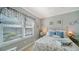 Inviting bedroom with a wrought iron bed frame, bright window, and blue accents for a serene feel at 7910 34Th W Ave # 203, Bradenton, FL 34209