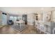Open-concept dining room showcasing a black hutch, bar seating, and connection to other living spaces at 7910 34Th W Ave # 203, Bradenton, FL 34209