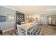 Bright dining room featuring a white wood table, chairs, and decorative hutch near the kitchen at 7910 34Th W Ave # 203, Bradenton, FL 34209