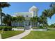 Stately two-story home with a prominent tower, lush landscaping, and a well-manicured lawn at 7910 34Th W Ave # 203, Bradenton, FL 34209