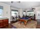 Bright game room features a billiard table, seating, and natural light from large windows at 7910 34Th W Ave # 203, Bradenton, FL 34209