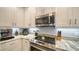 Well-equipped kitchen with stainless steel appliances, granite countertops, and white cabinetry at 7910 34Th W Ave # 203, Bradenton, FL 34209