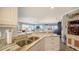 Spacious kitchen with granite countertops, stainless steel sink, and view to the dining and living areas at 7910 34Th W Ave # 203, Bradenton, FL 34209
