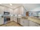 Modern kitchen featuring white cabinets, granite countertops, stainless steel appliances, and an open layout at 7910 34Th W Ave # 203, Bradenton, FL 34209