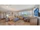 Inviting living room with tan sofas, decorative rug, and large window offering plenty of natural light at 7910 34Th W Ave # 203, Bradenton, FL 34209