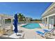 Community pool with lounge chairs, umbrellas, and view of the surrounding landscape and buildings at 7910 34Th W Ave # 203, Bradenton, FL 34209