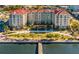 Stunning waterfront condo building featuring lush landscaping, a private pier, and resort-style amenities at 808 3Rd W Ave # 205, Bradenton, FL 34205