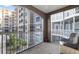 Relaxing screened balcony with seating and views of building exterior at 808 3Rd W Ave # 205, Bradenton, FL 34205