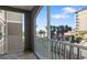 Screened-in balcony offering serene views of the landscaped grounds and water at 808 3Rd W Ave # 205, Bradenton, FL 34205