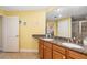 Bathroom vanity with double sinks, granite countertop, wood cabinets and tile floors at 808 3Rd W Ave # 205, Bradenton, FL 34205