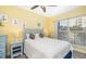 Bright bedroom boasts natural light, ceiling fan, and coastal decor at 808 3Rd W Ave # 205, Bradenton, FL 34205