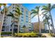 Beautiful condo building with private balconies overlooking lush landscaping and sparkling blue skies at 808 3Rd W Ave # 205, Bradenton, FL 34205