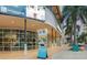 Exterior street view of the building with modern architecture, palm trees, and walking distance to local shops at 808 3Rd W Ave # 205, Bradenton, FL 34205