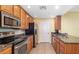 Kitchen with stainless steel appliances, granite countertops, and ample cabinet space at 808 3Rd W Ave # 205, Bradenton, FL 34205