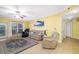 Inviting living room with comfortable seating, tile floors, and a ceiling fan at 808 3Rd W Ave # 205, Bradenton, FL 34205