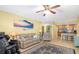 Comfortable living room with ceiling fan, tile floors, and adjacent kitchen at 808 3Rd W Ave # 205, Bradenton, FL 34205