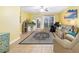 Bright living room with tile flooring, ceiling fan, and sliding door to balcony at 808 3Rd W Ave # 205, Bradenton, FL 34205
