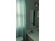 Well-lit bathroom with white fixtures and sheer blue curtains at 820 Coconut Rd, Venice, FL 34293