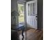 Welcoming entryway with a glass paneled door, wood floors, and decorative lighting at 820 Coconut Rd, Venice, FL 34293