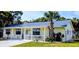 Charming single-story home featuring a welcoming front porch and beautiful landscaping at 820 Coconut Rd, Venice, FL 34293