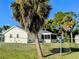 Charming single-Gathering home with a fenced yard, surrounded by lush greenery and mature trees at 820 Coconut Rd, Venice, FL 34293