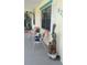 Charming front porch with colorful chairs and decor, creating a welcoming entryway to the home at 820 Coconut Rd, Venice, FL 34293