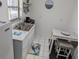Efficient kitchen with stainless steel sink, white cabinets, and a breakfast table at 820 Coconut Rd, Venice, FL 34293