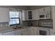 Updated kitchen boasting white cabinets, countertops, and modern appliances at 820 Coconut Rd, Venice, FL 34293