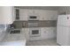 Modern white kitchen featuring stainless steel appliances and sleek countertops at 820 Coconut Rd, Venice, FL 34293