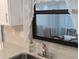 Kitchen sink with modern faucet, window and view of outside at 820 Coconut Rd, Venice, FL 34293