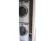 A stacked washer and dryer unit in a closet is designed for efficient laundry at 820 Coconut Rd, Venice, FL 34293
