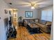 Well-lit living room with a comfortable sectional, entertainment center, and views into other rooms at 820 Coconut Rd, Venice, FL 34293