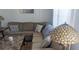 Cozy living room featuring a comfortable sectional sofa and stylish decorative lamps at 820 Coconut Rd, Venice, FL 34293