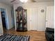 Open living room with hardwood floors, curio cabinet, and easy access to other rooms at 820 Coconut Rd, Venice, FL 34293