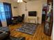 Living room with laminate flooring, TV console, and nautical decor at 820 Coconut Rd, Venice, FL 34293