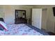Main bedroom with decorative dresser and a doorway to the walk-in closet at 820 Coconut Rd, Venice, FL 34293