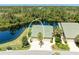 Aerial view of a home featuring a lush yard with a pond at 8556 54Th Avenue E Cir, Bradenton, FL 34211