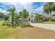 Exterior of clubhouse featuring outdoor seating areas, lush landscaping, and a welcoming entrance at 8556 54Th Avenue E Cir, Bradenton, FL 34211