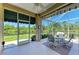 A covered screened patio with a view of the beautiful lake and foliage at 8556 54Th Avenue E Cir, Bradenton, FL 34211