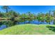 Beautiful view of the pond showcasing lush greenery, water reflections, and mature trees at 8556 54Th Avenue E Cir, Bradenton, FL 34211