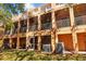 Back exterior showing multiple units with balconies and a well-maintained lawn at 8662 Majestic Elm Ct, Lakewood Ranch, FL 34202