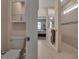 Bathroom with a toilet, shower, and view to bedroom, and tiled flooring at 8726 Backshore Ln, Parrish, FL 34219