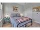 Comfortable bedroom with bed, side table and artwork, plus closet doors for storage at 8726 Backshore Ln, Parrish, FL 34219