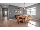 Elegant dining room featuring a wooden table, stylish chandelier, and neutral decor at 8726 Backshore Ln, Parrish, FL 34219