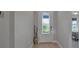 Welcoming home foyer boasts wood-look tile flooring and a decorative glass front door at 8726 Backshore Ln, Parrish, FL 34219