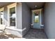 Inviting entryway with a decorative glass front door, stone tile floor, and gray walls at 8726 Backshore Ln, Parrish, FL 34219
