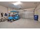 Attached garage featuring epoxy flooring, storage, and a golf cart at 8726 Backshore Ln, Parrish, FL 34219