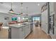 Bright and spacious kitchen area with a large center island and modern appliances, leading into the living space at 8726 Backshore Ln, Parrish, FL 34219
